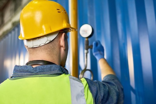 plumber working on water heater pipes