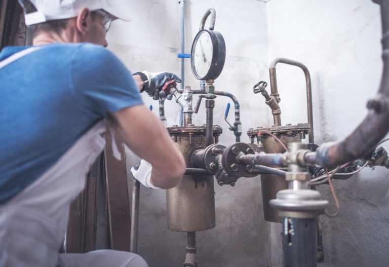 Plumber working on residential pipes.