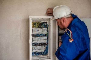 Electrician checking the service panel for upgrades