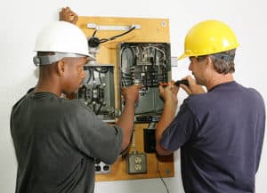 Electrician working on to fix the breaker box in independence