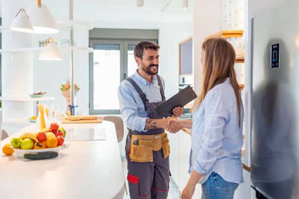 Customer and professional installer discussing about the insurance of their bathroom remodeling