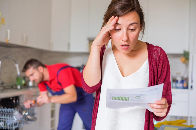 Woman Comparing Repair Quotes and Estimates for the repair of water heater.