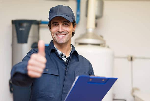 technician servicing a water heater.