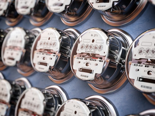 Electric meters in a row measuring power use and consumption