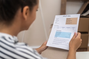 woman looking at her lowered utility bill by availing professional commercial plumbing services