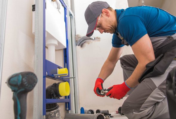 plumber installing pvc pipes in a home